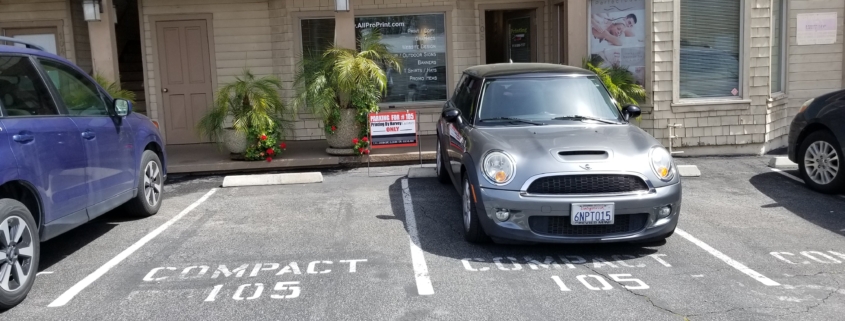 Gray Mini Cooper parked in compact parking spot