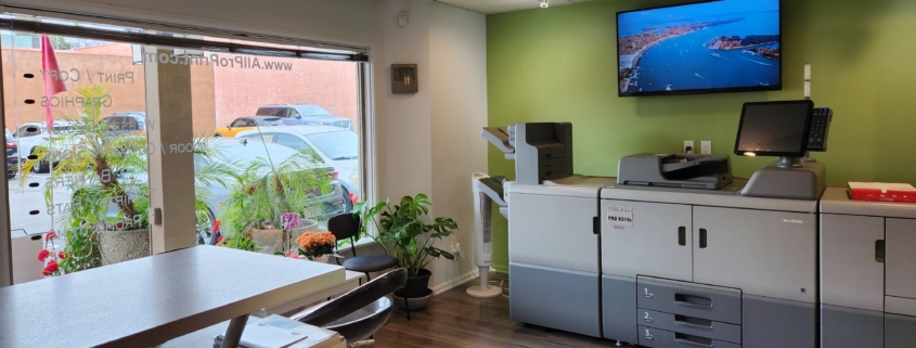 Print shop interior with large printers and plants