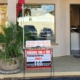 Print shop storefront with reserved parking sign