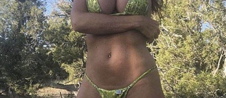 Woman in green bikini posing outdoors