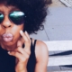 Person with sunglasses making a kissy face