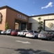 Casino entrance with parked cars and palms