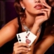 Glamorous woman holding poker aces with chips