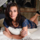 Woman reclining on bed in lace dress