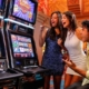 Three friends cheering at casino slot machines