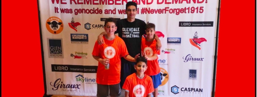 Children posing in front of Armenian remembrance backdrop
