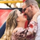 Smiling couple embracing by colorful playground slide