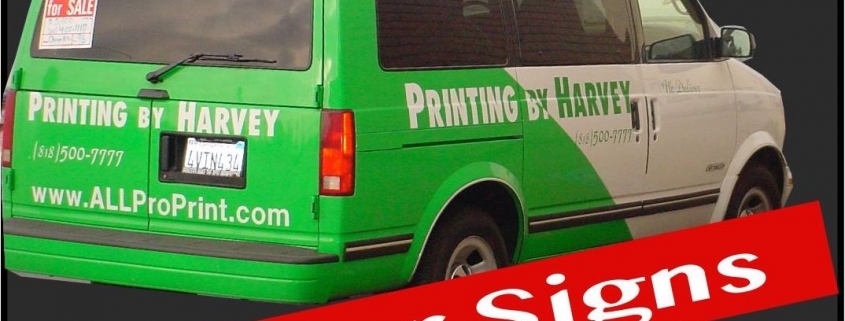 Green van with "Printing by Harvey" signage
