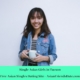 Smiling woman holding mug in denim jacket