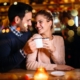 Smiling couple sharing coffee at cozy cafe