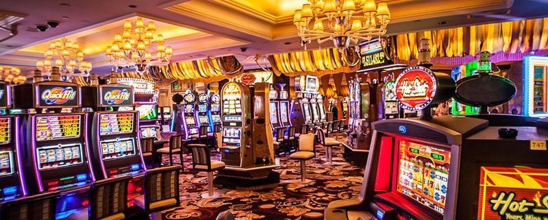 Colorful casino slot machines under chandeliers