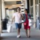 Smiling couple walking with shopping bags