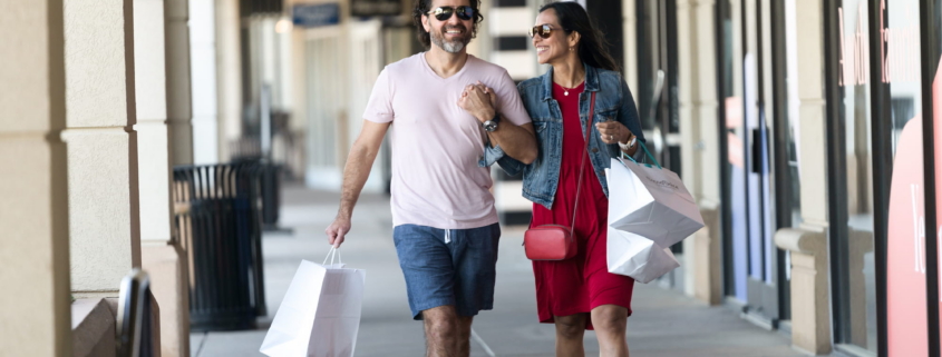 Smiling couple walking with shopping bags