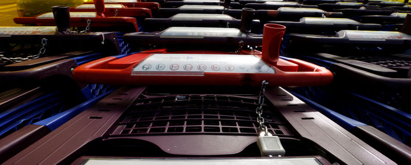 Carrefour shopping carts lined up under canopy