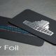 Black foil-stamped business cards with logo