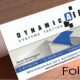Folded Dynamic Air business card on wooden table
