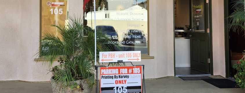 Printing shop storefront with parking sign