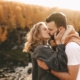 Couple kissing outdoors in autumn forest