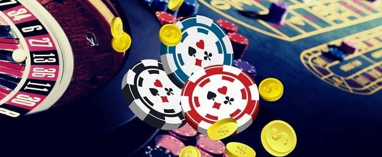 Roulette wheel and poker chips on table