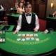 Live casino dealer at card table