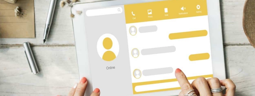 Hands tapping messaging app on tablet