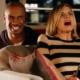 Man smiling, woman shocked on couch