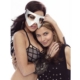 Two women embracing, one wearing white mask