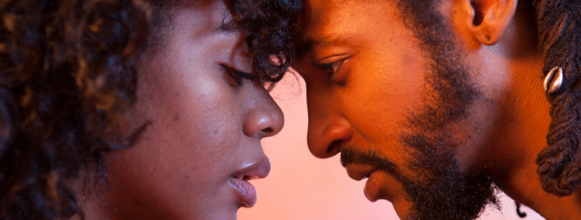 Intimate close-up of two people touching foreheads