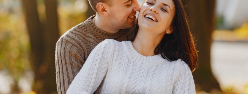 Happy couple embracing in autumn park