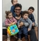 Man with four children holding colorful toy