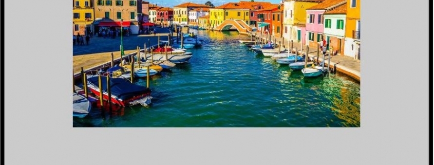 Colorful canal lined with houses and boats