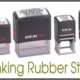 Row of four self-inking rubber stamps