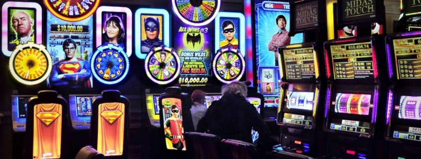 People at brightly lit casino slot machines
