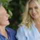Smiling middle-aged couple outdoors under leafy trees