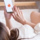 Woman using dating app in bed
